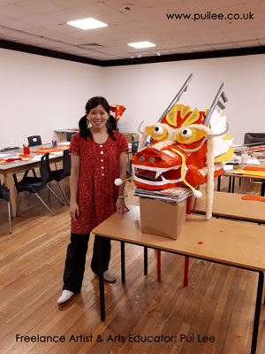Artist Pui Lee and the finished giant dragon head